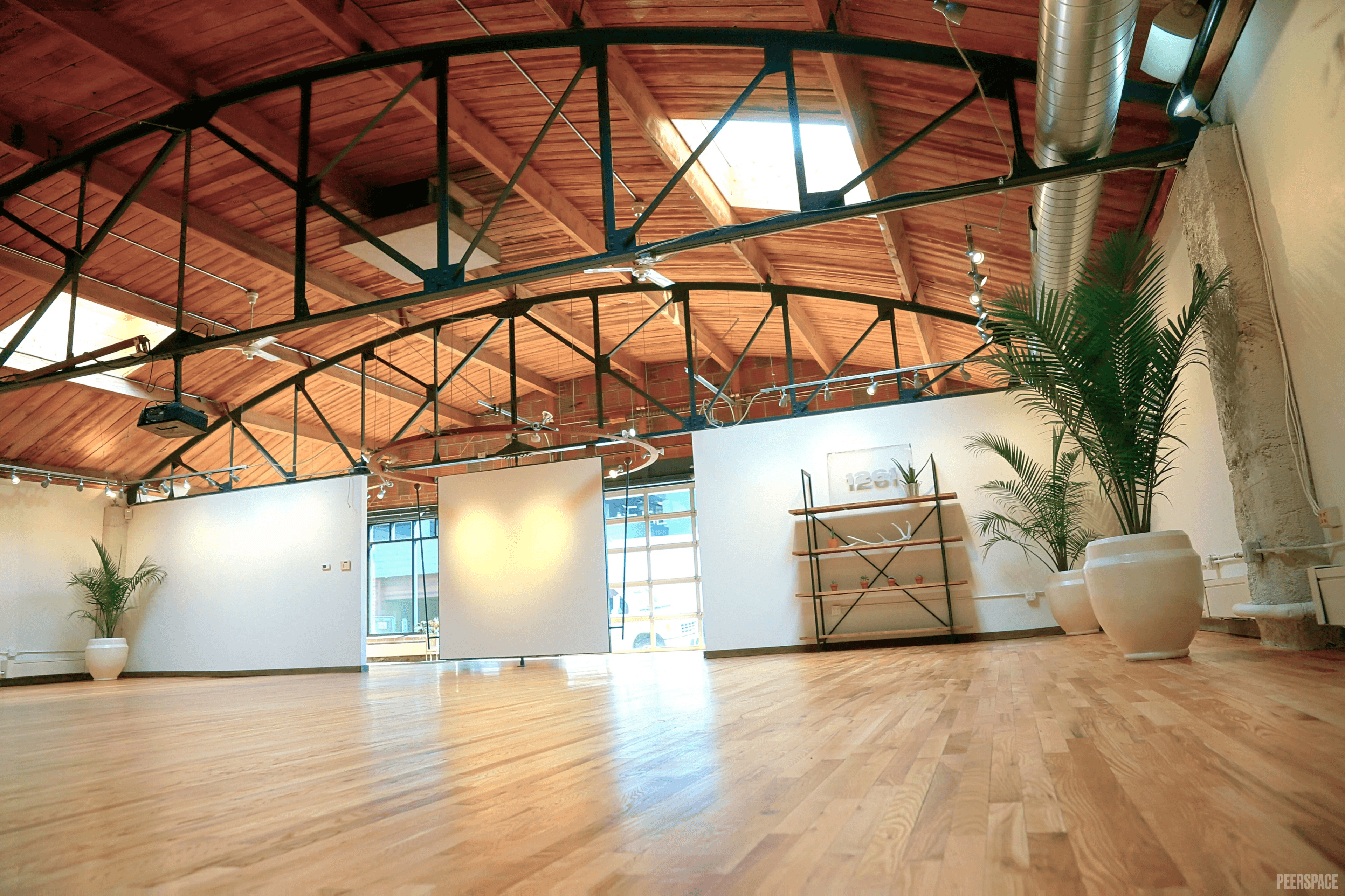 Sterling Event Space configured for a corporate presentation, projector deployed, full daylight