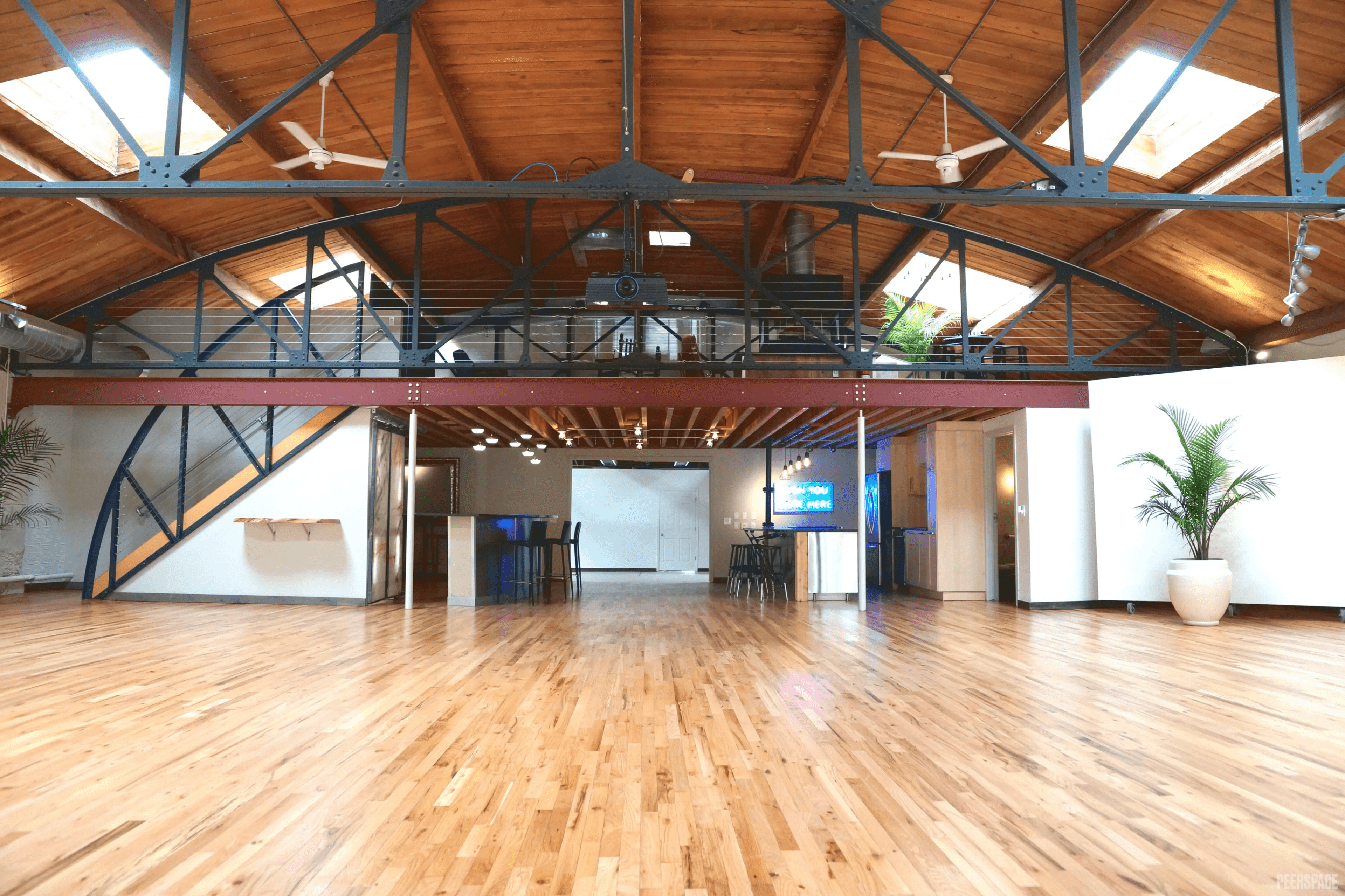 Sterling Event Space interior — hardwood floors, 30-foot barrel-vaulted ceiling and loft, Denver Golden Triangle event venue