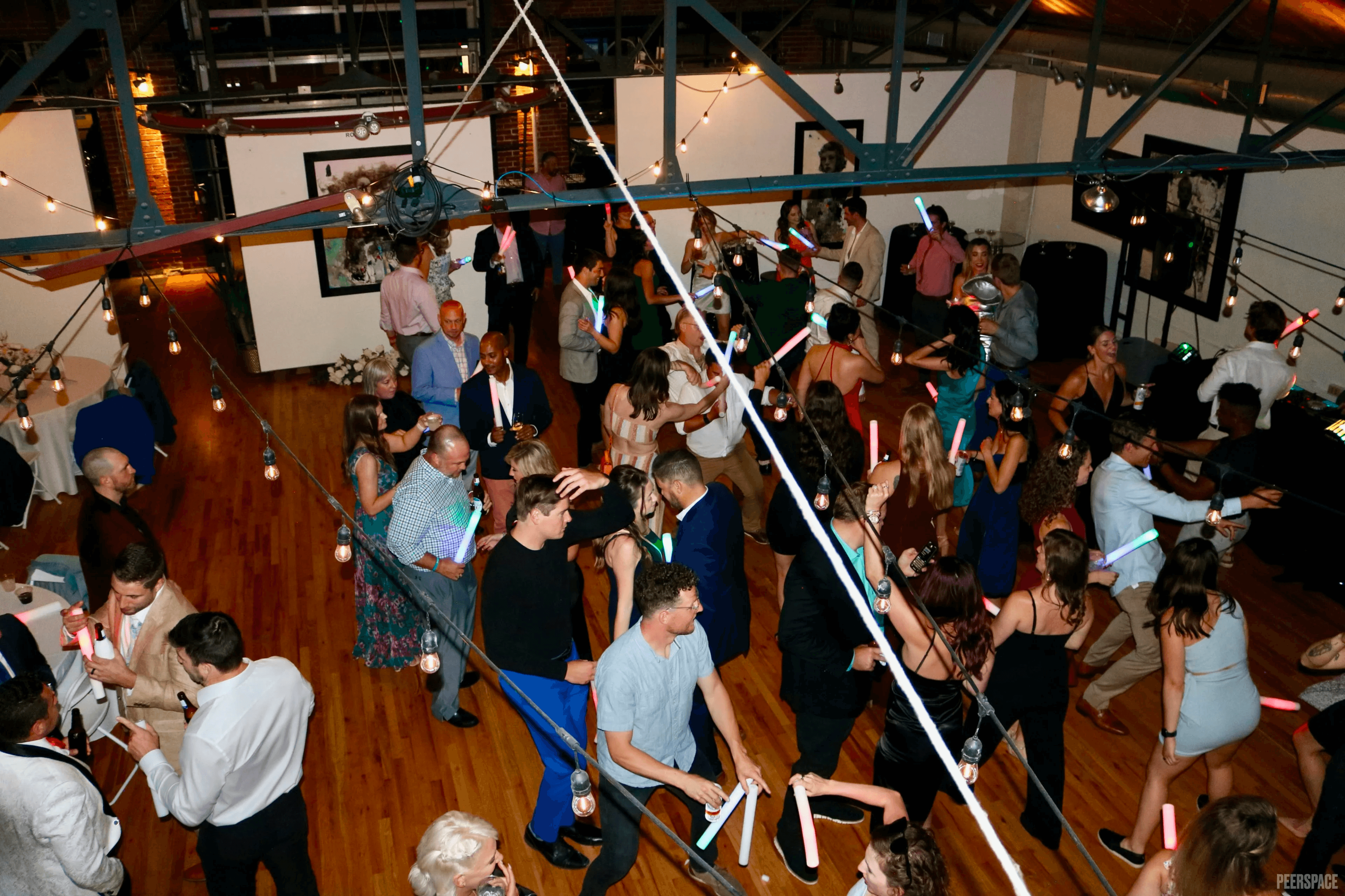 Wedding dance floor with glow sticks and string lights